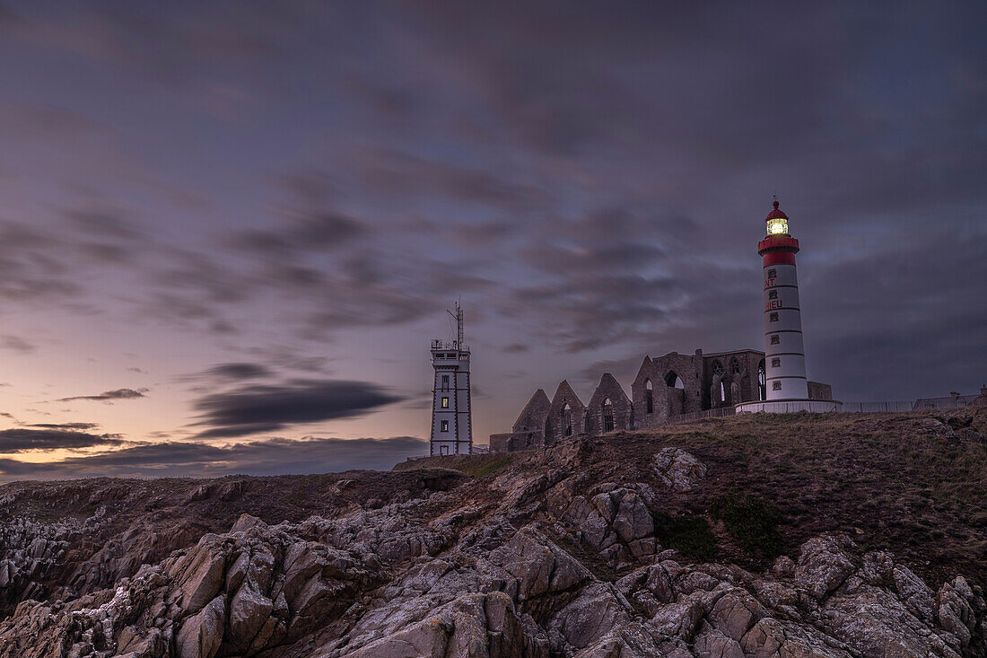 France, Brittany, Plougonvelin. Atlantic Ocean near the ruins of the Abbey of Saint Mathieu and the Saint Mathieu Lighthouse at sunset