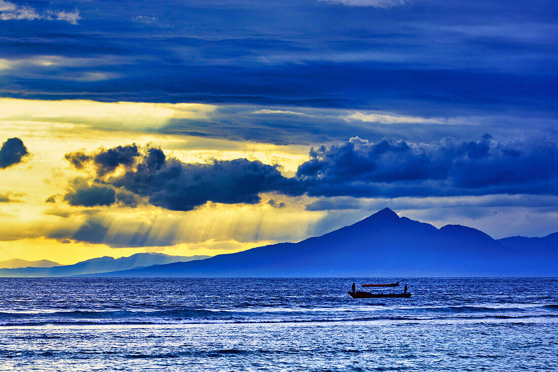 Late sunset view of Mount Agung volcano on the island of Bali, Indonesia. An active volcano rising 3,014 meters (9,888') is the second highest volcano in Indonesia. Gunung Agung (Great Mountain)