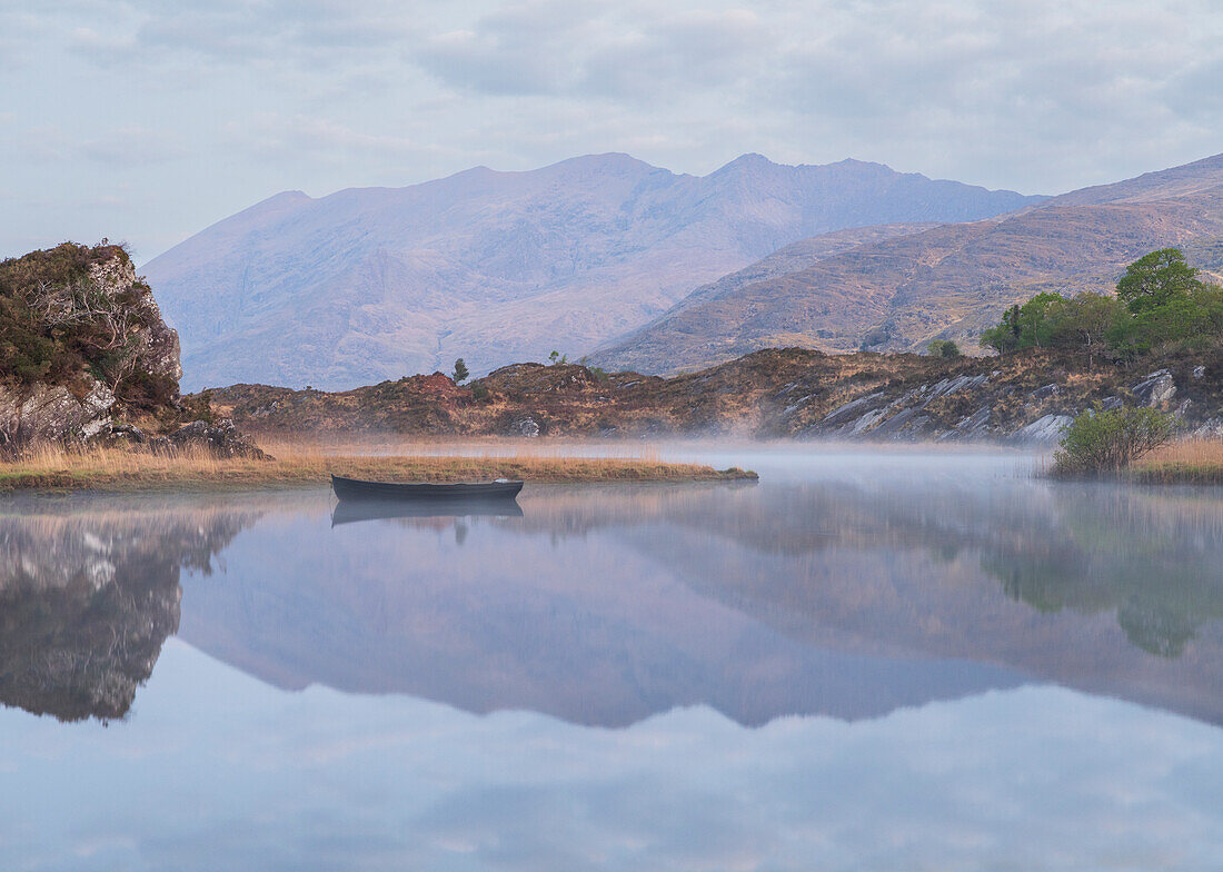 Ireland, Lough Leane. Boat and reflections on lake.