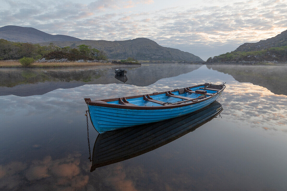 Ireland, Lough Leane. Boat and reflections on lake.