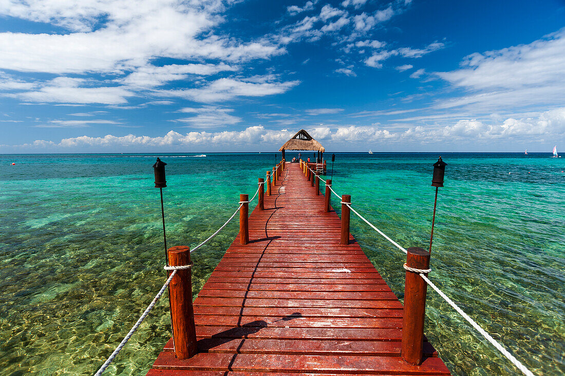 A pier and a palapa on a beach on Cozumel Island, Quintana Roo, Mexico.