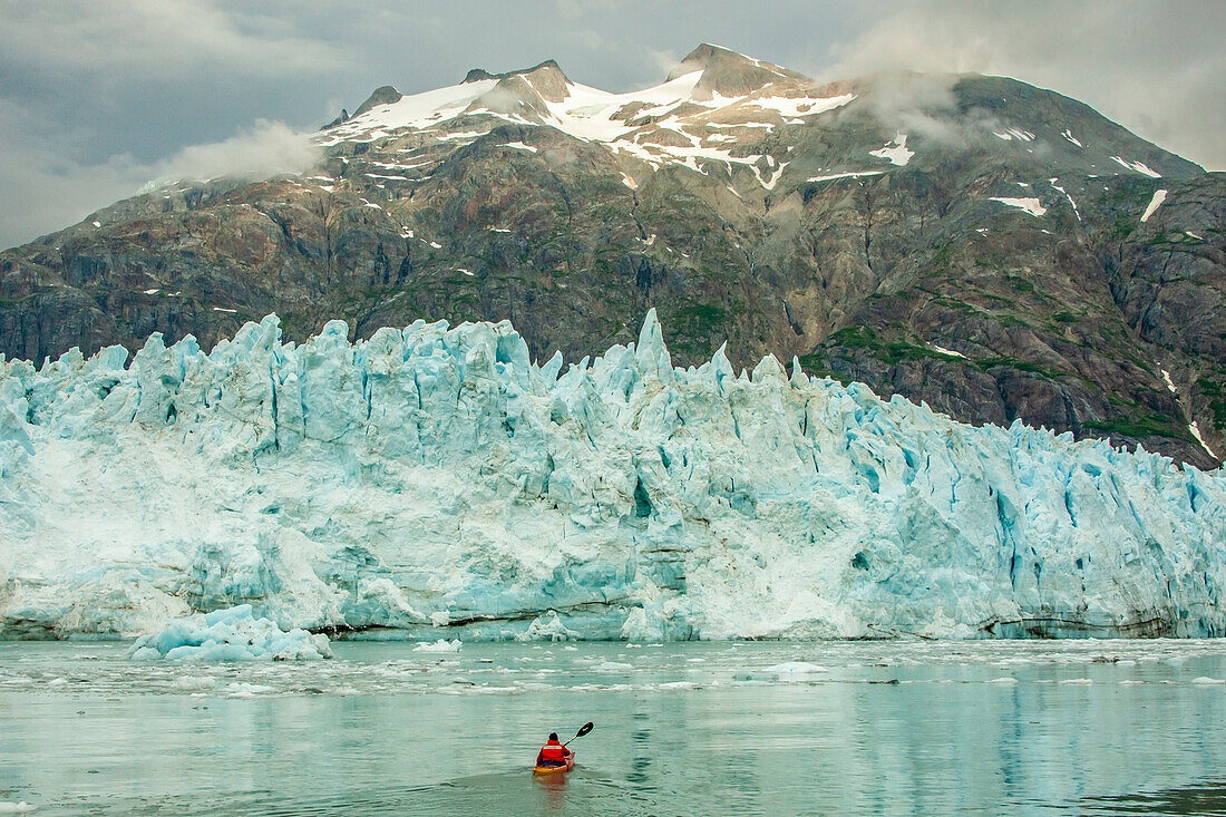 USA, Alaska, Glacier Bay National Park. Margerie Glacier ice and man in kayak