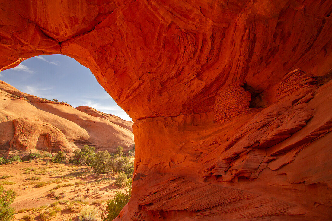 USA, Arizona, Monument Valley Navajo Tribal Park. Honeymoon Arch shelter in rock overhang.