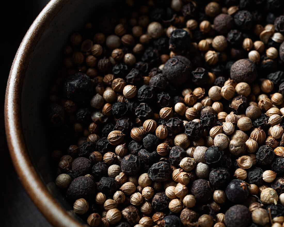 Closeup of a plate full of peppercorns viewed from above