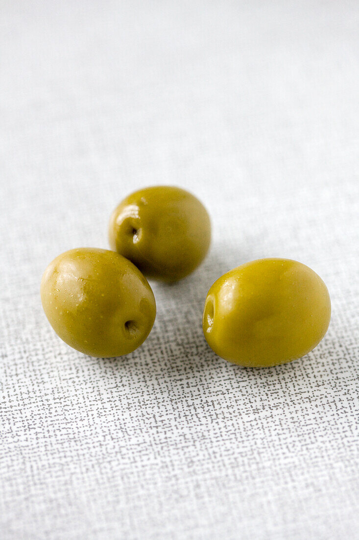 Green olives on a white background