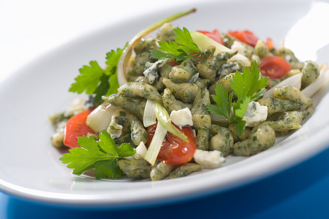 Herb spaetzle with feta cheese and tomatoes