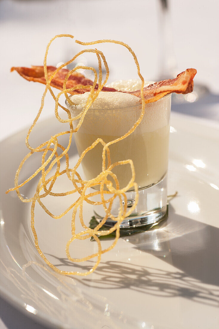 Potato soup in a jar with fried bacon and potato straw