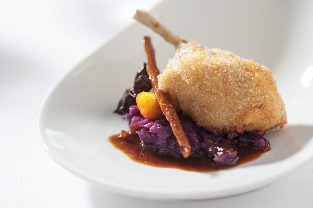 Duck wrapped in pastry on spiced red cabbage