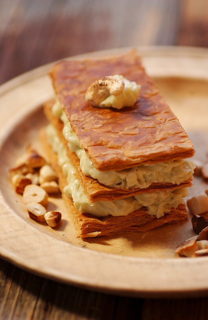 Piquant puff pastry slices with celery salsa and nuts