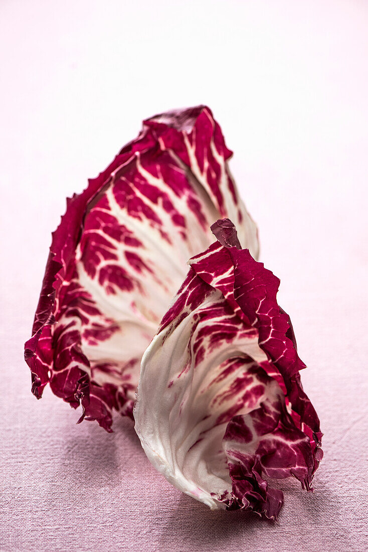 Radicchio leaves on pink background