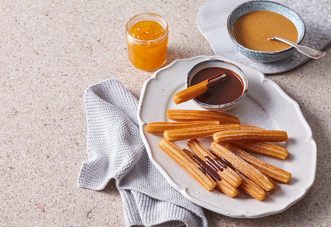 Churros with chocolate, caramel and mango sauce