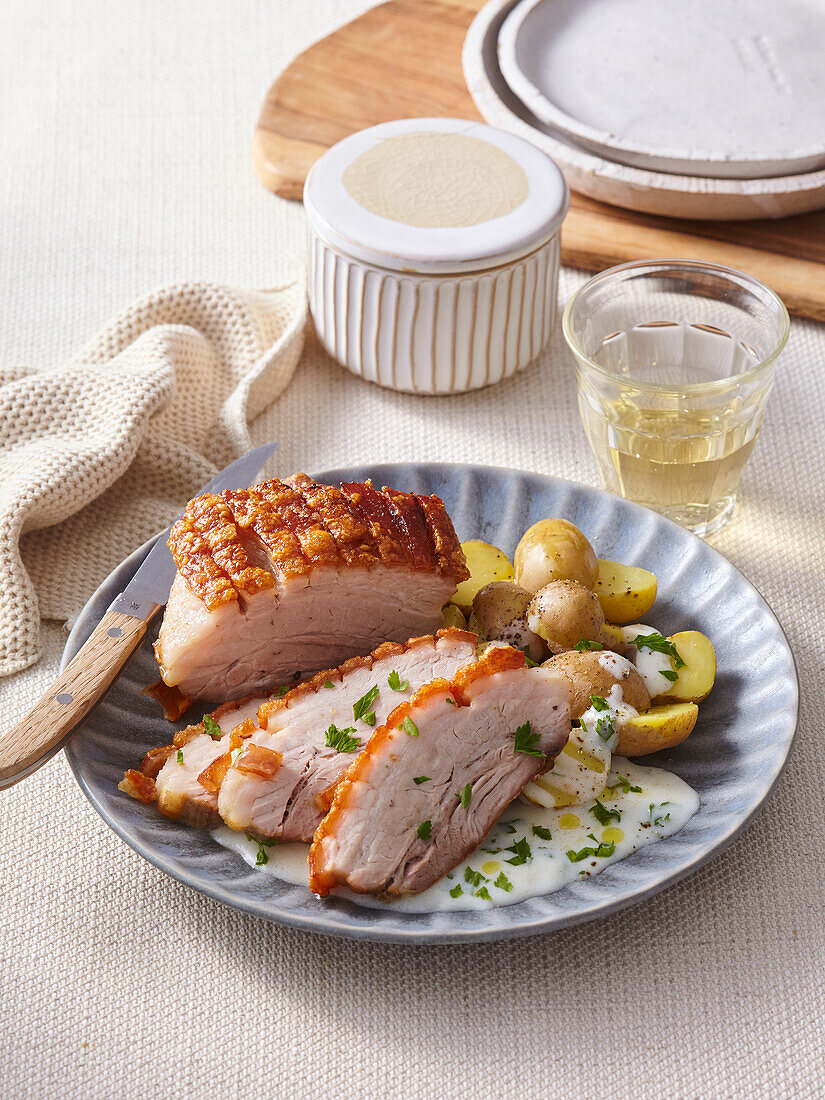 Crispy pork belly with potatoes and parsley sauce