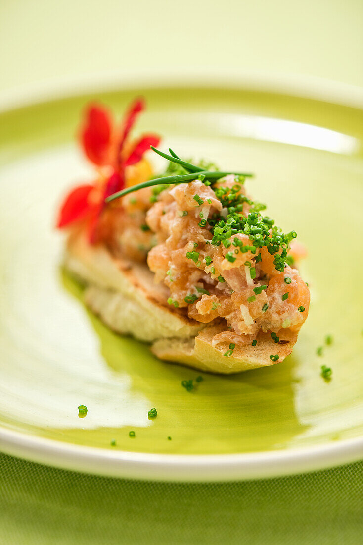 Salmon trout tartare on a baguette roll