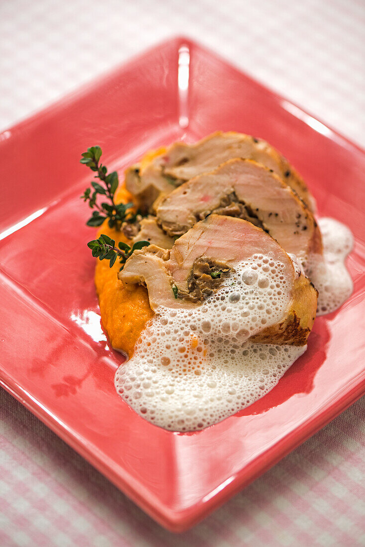 Corn-fed chicken breast with porcini mushroom filling on carrot puree and thyme cream sauce