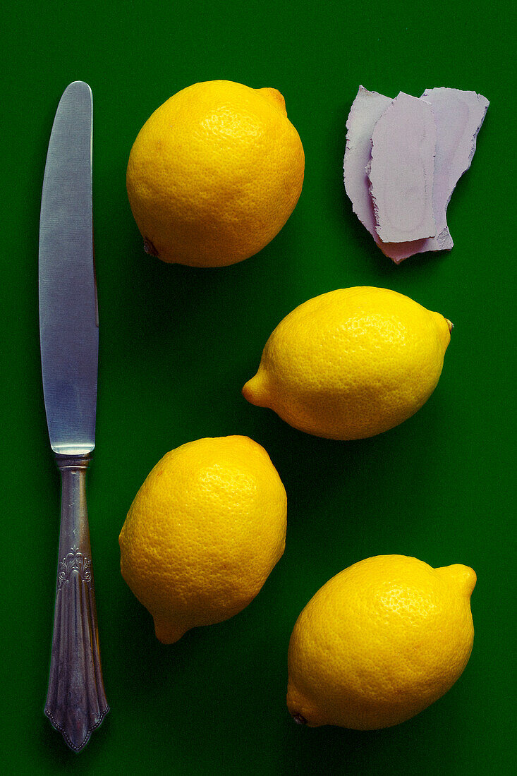 Four whole lemons with knife