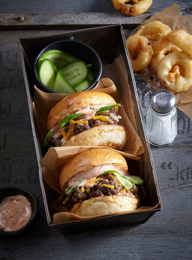 Cheeseburger with cocktail sauce and deep-fried onion rings