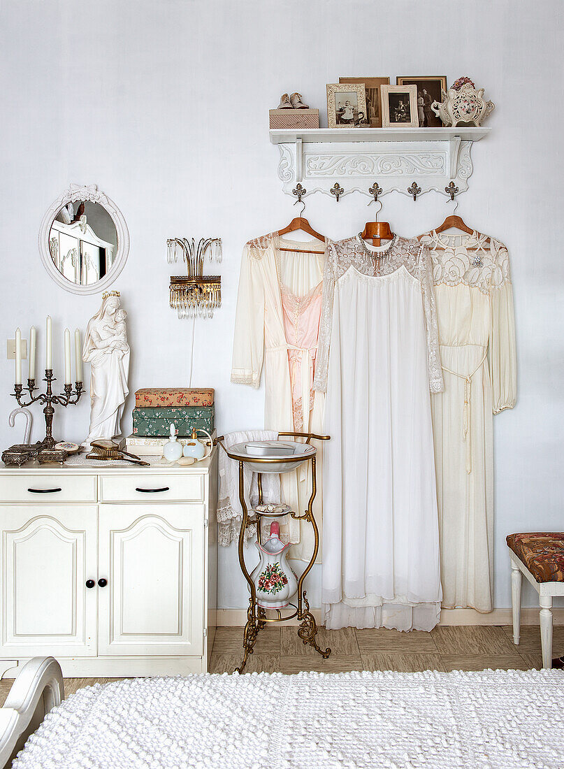 Bedroom with antique decor and vintage dresses on wardrobe