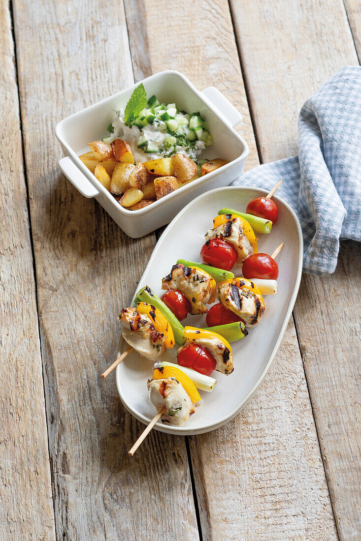 Chicken and vegetable skewers and roast potatoes