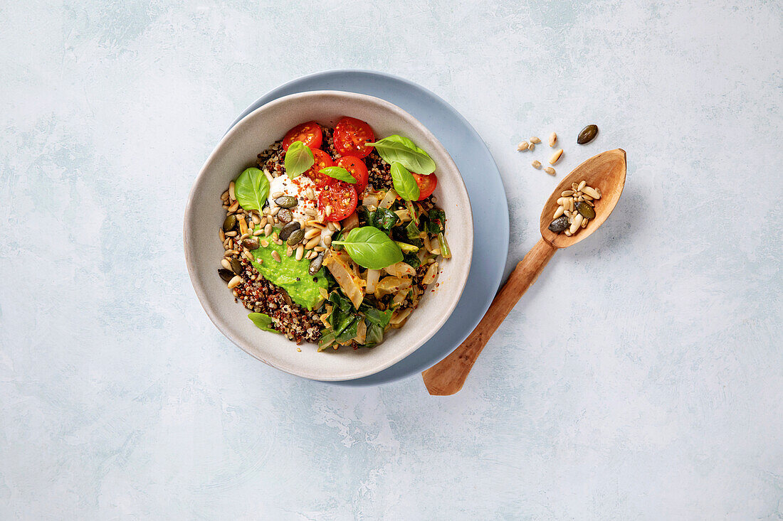 Chard and quinoa bowl with tomatoes and seeds