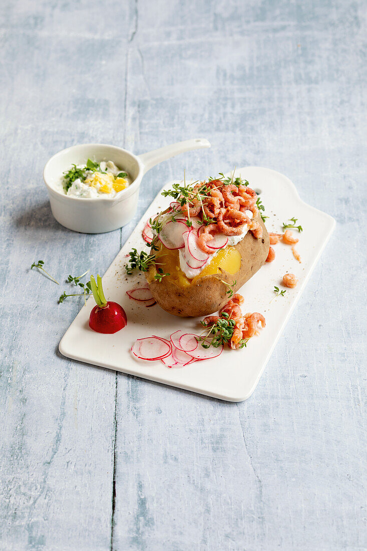 Jacket potato with prawns, radishes and cream cheese dip