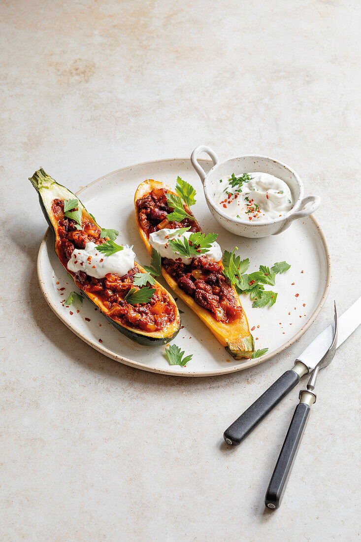 Stuffed courgette boats with tomato ragout and yoghurt dip