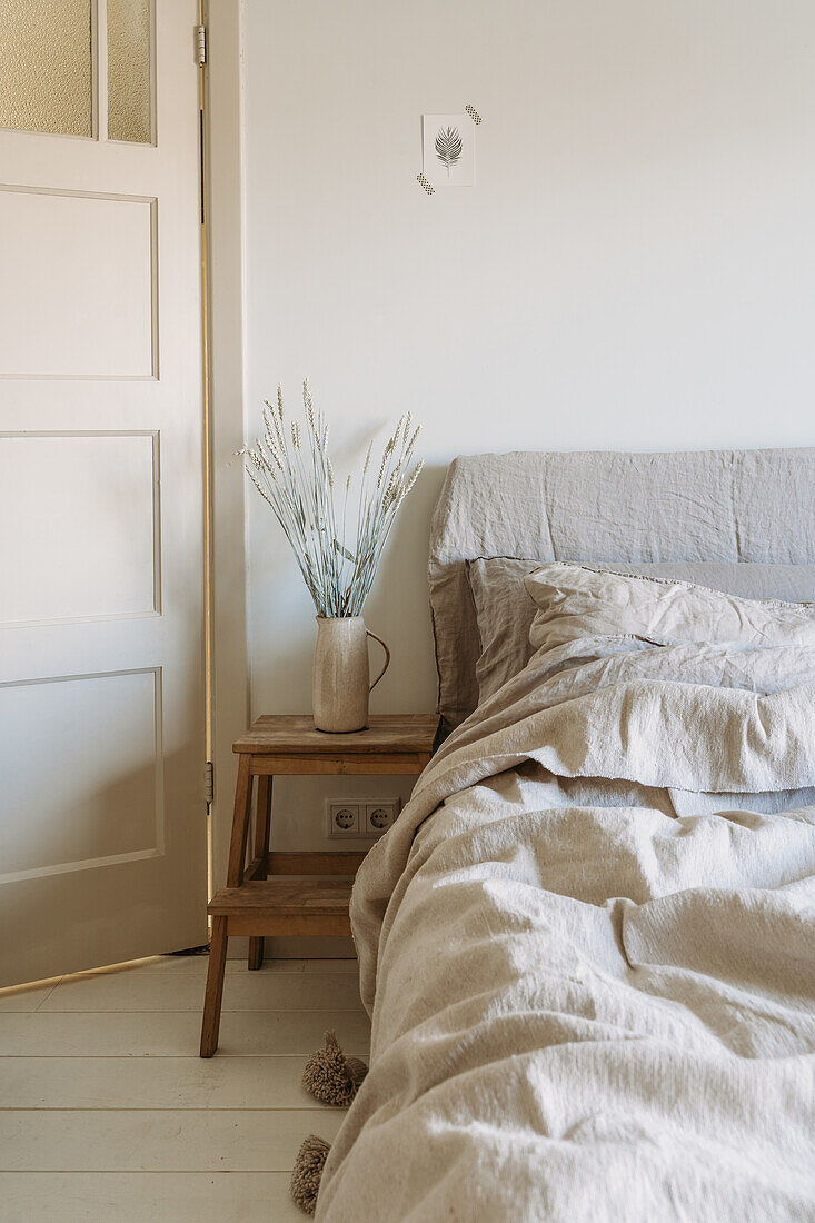 Bedroom with linen bed linen and decorations made from natural materials