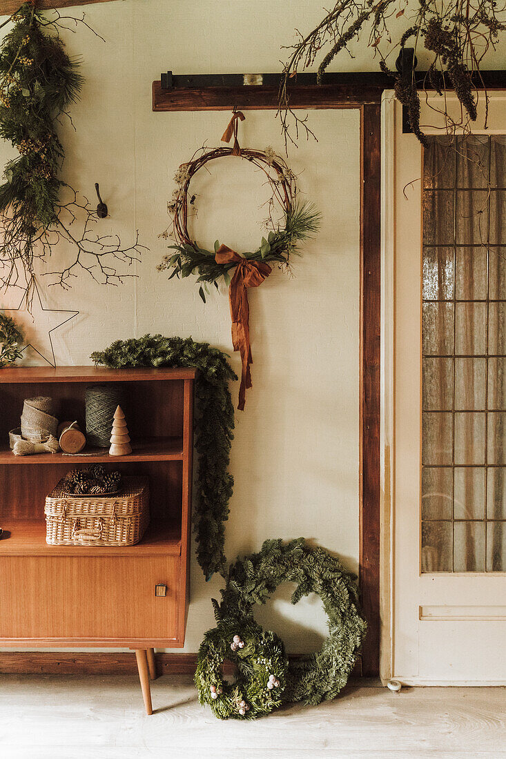 Christmas decoration with wreaths and fir garland in the entrance area