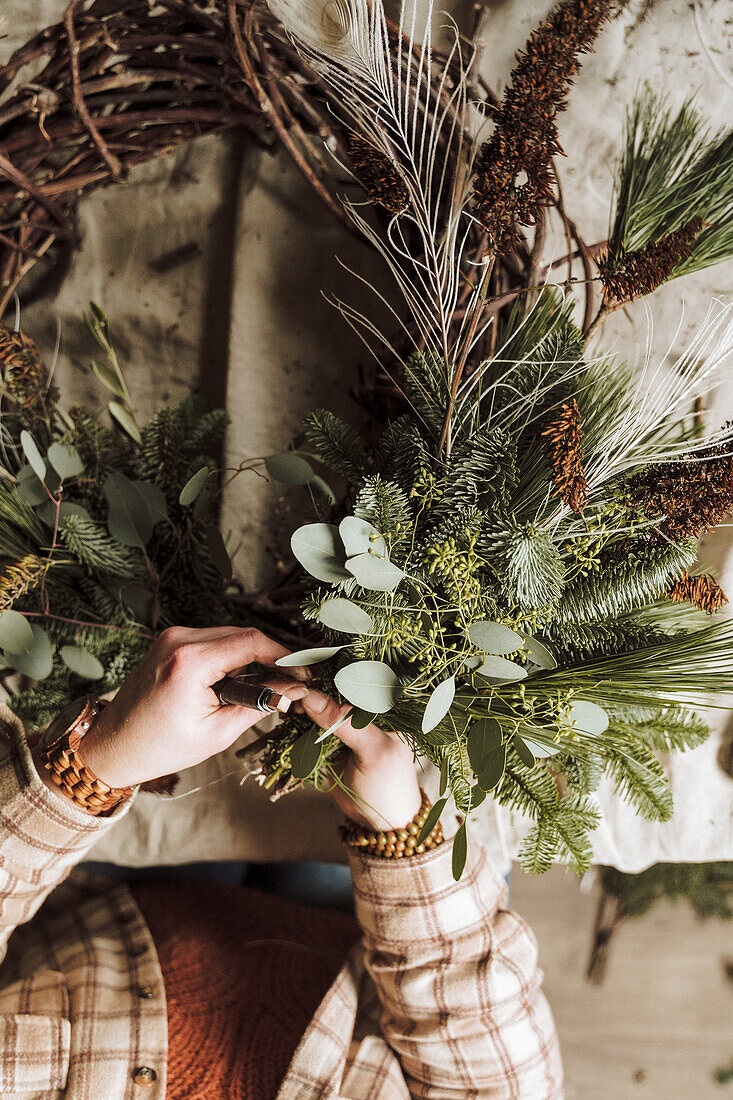 A DIY Christmas wreath is made from twigs, eucalyptus and cones