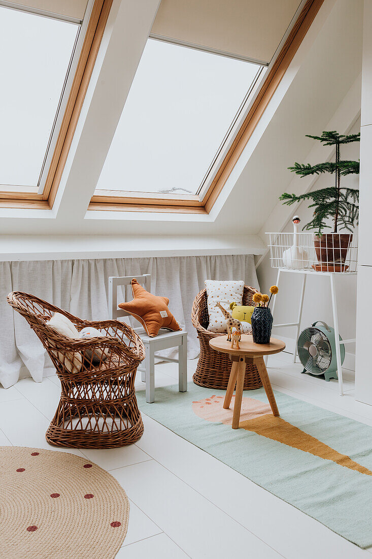 Scandinavian-style children's room with rattan armchairs and skylights