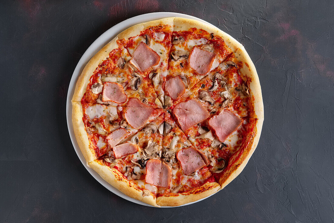 Pizza with ham and mushrooms