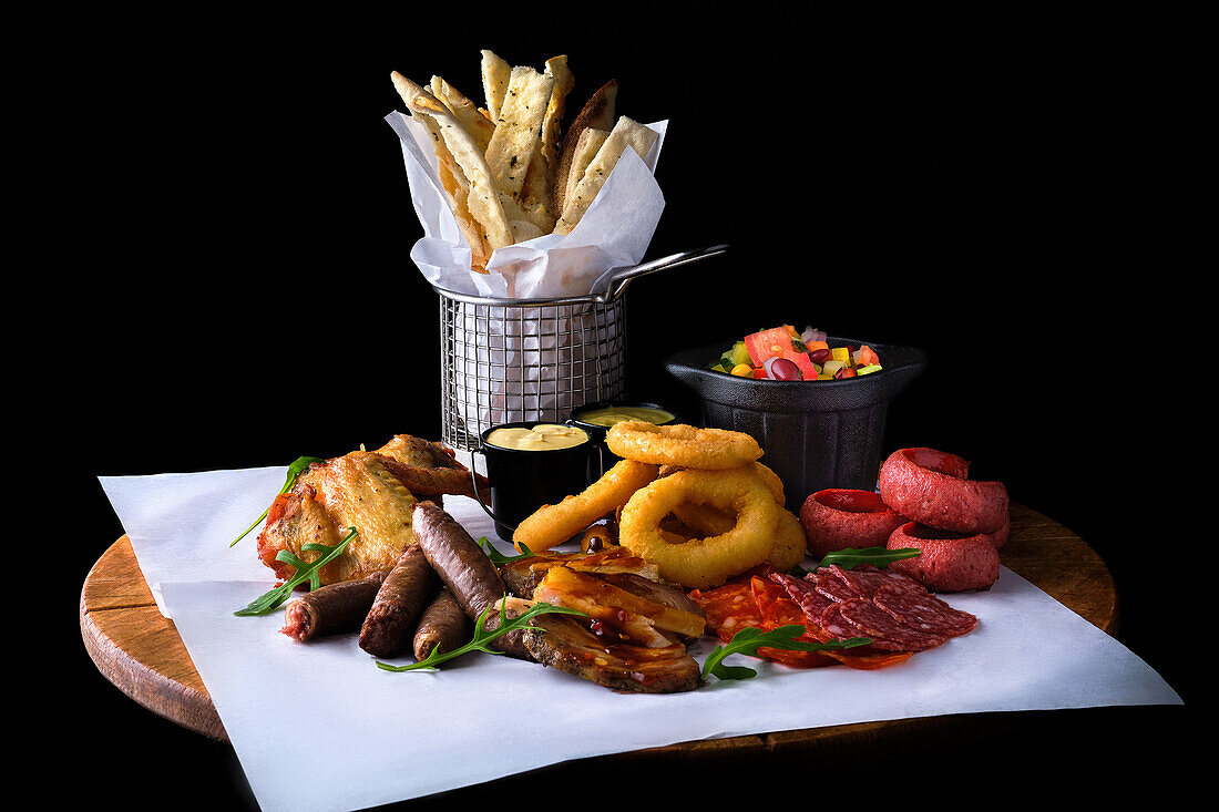 Beer snack platter with various appetisers and dips