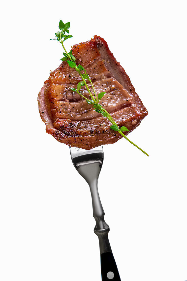 Roasted piece of beef on a fork