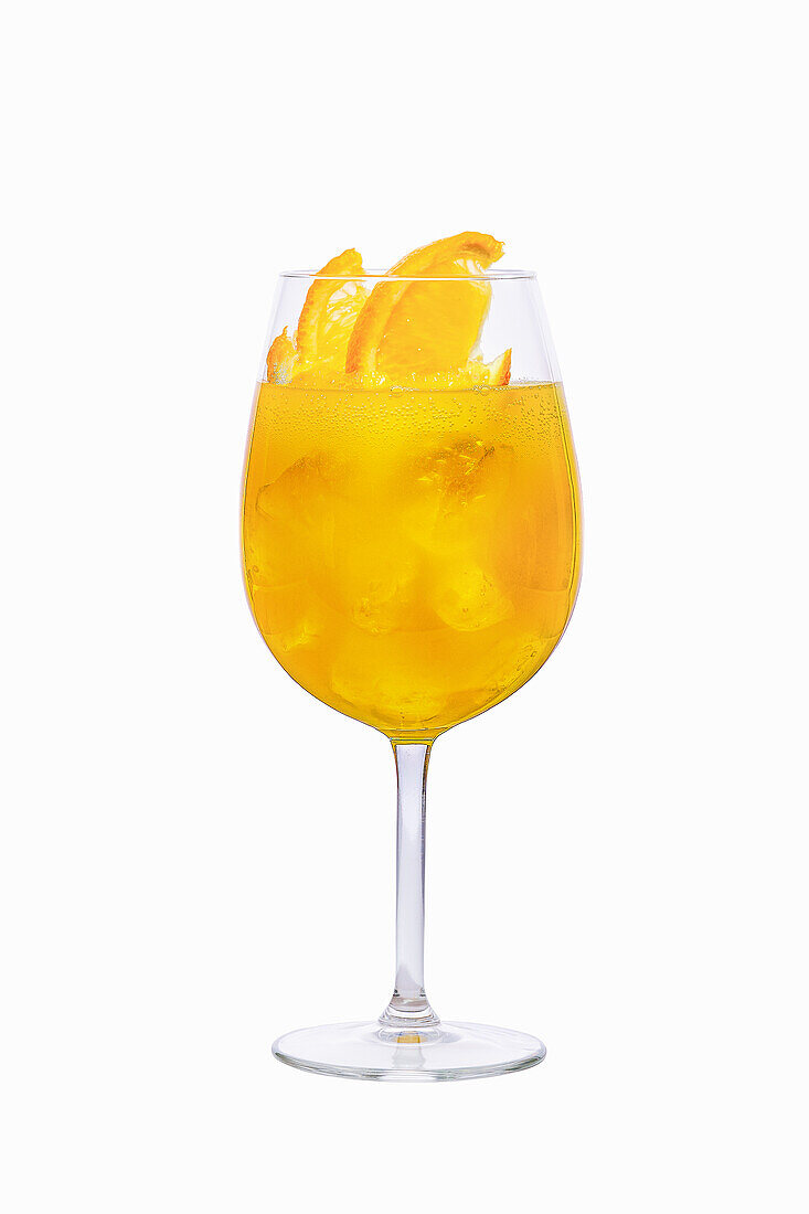 Yellow sangria with orange slices and ice cubes