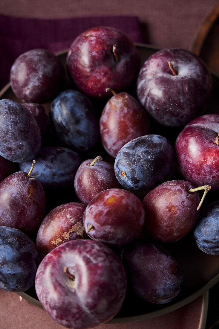 Still life with fresh red and blue plums