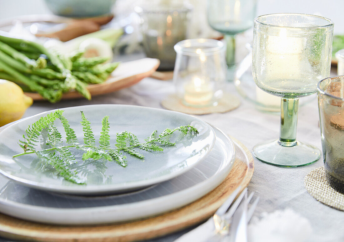 Spring table decoration with fern leaves and asparagus