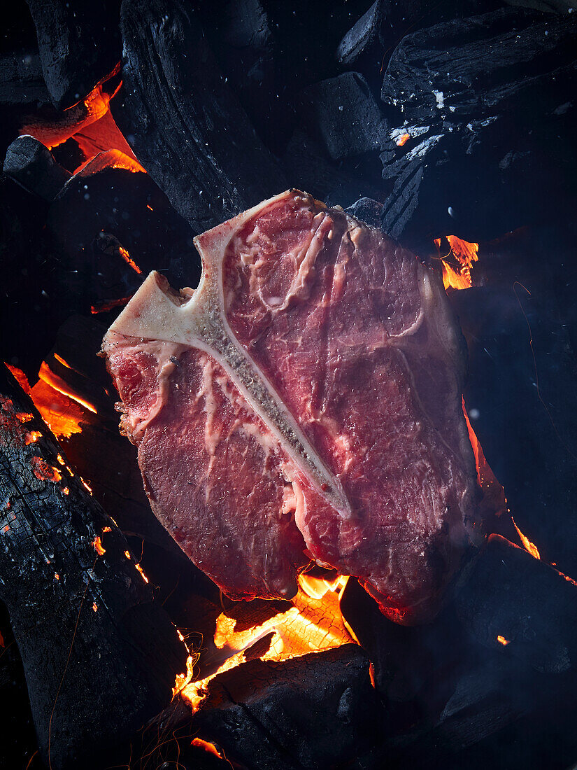 T-bone steak on hot embers