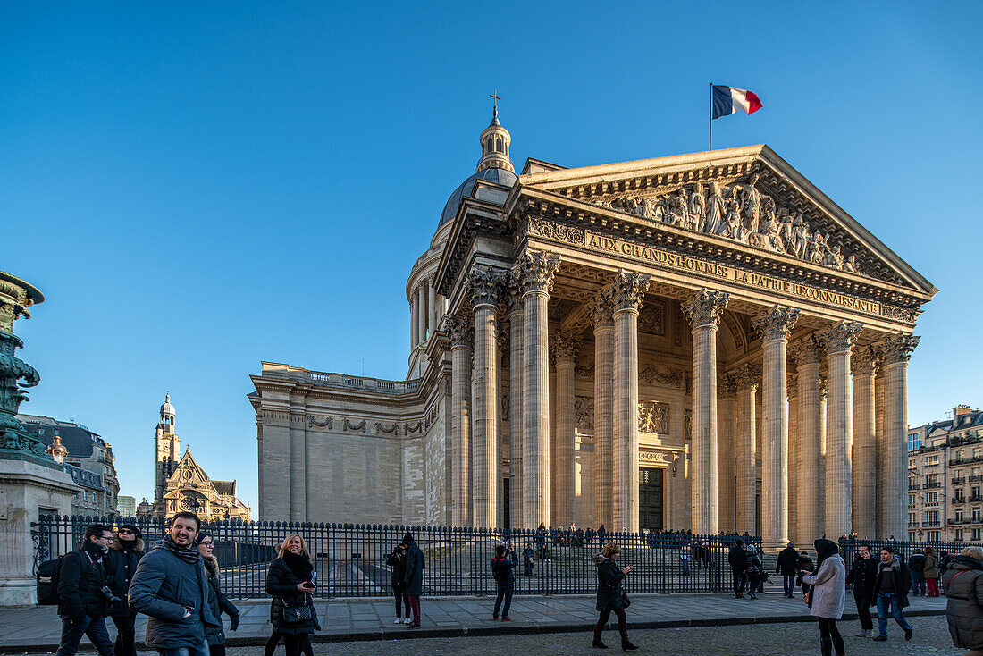 Bustling street scene in front of the Panthéon, with Saint-Etienne-du-Mont in the background.