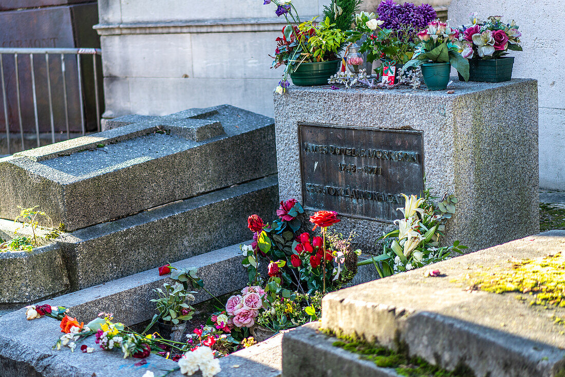 Jim Morrison's final resting place adorned with colorful flowers.