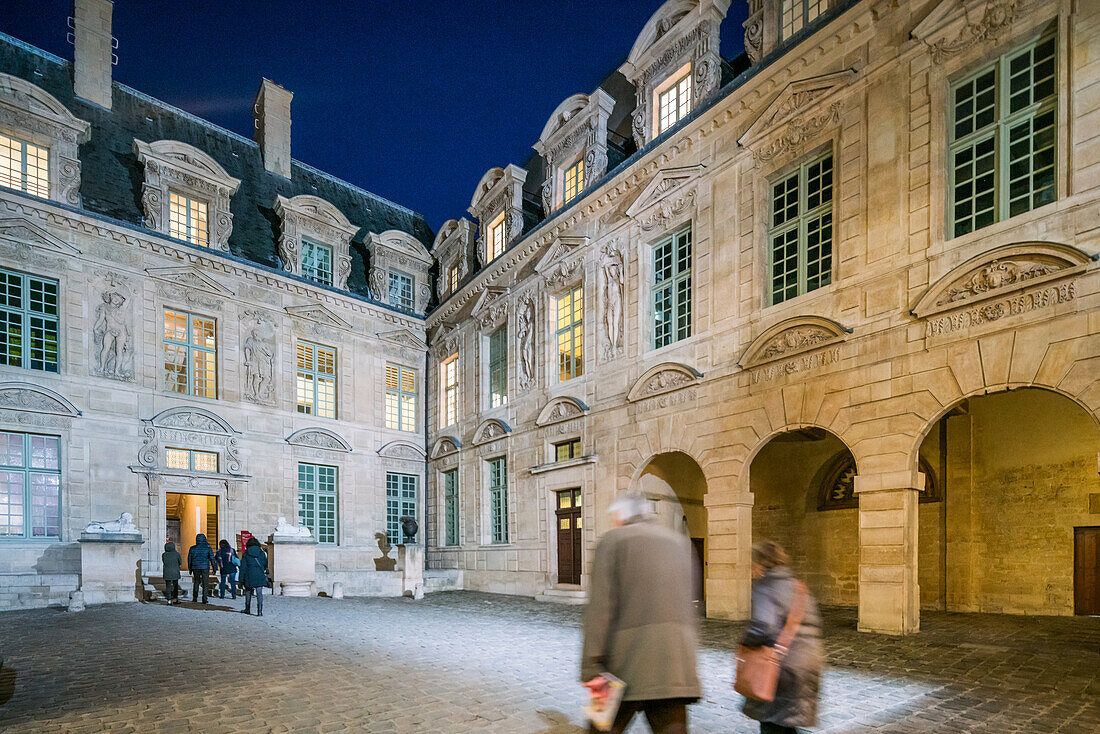 Hotel de Sully, a private mansion in the Marais, Paris, illuminated at dusk.