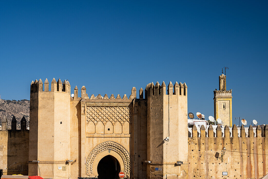 Bab Chorfa, the historic entrance to Fez's medina, stands under a clear sky.