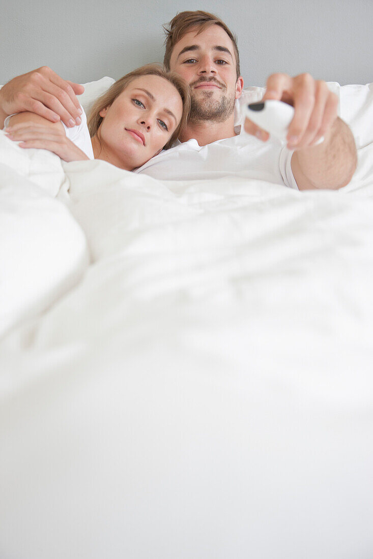 Couple in Bed Watching TV