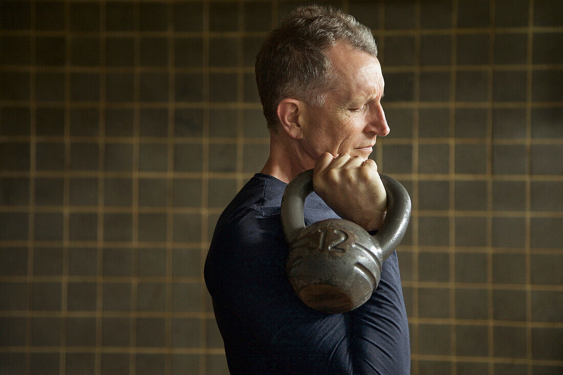 Profile of Mature Man Lifting Kettlebell