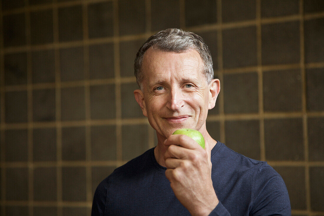 Mature Man Holding an Apple