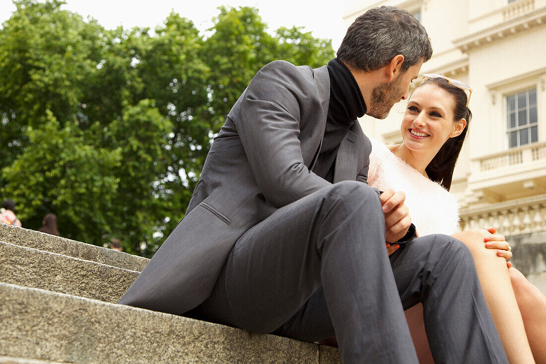 Couple Sitting on Steps Outdoors