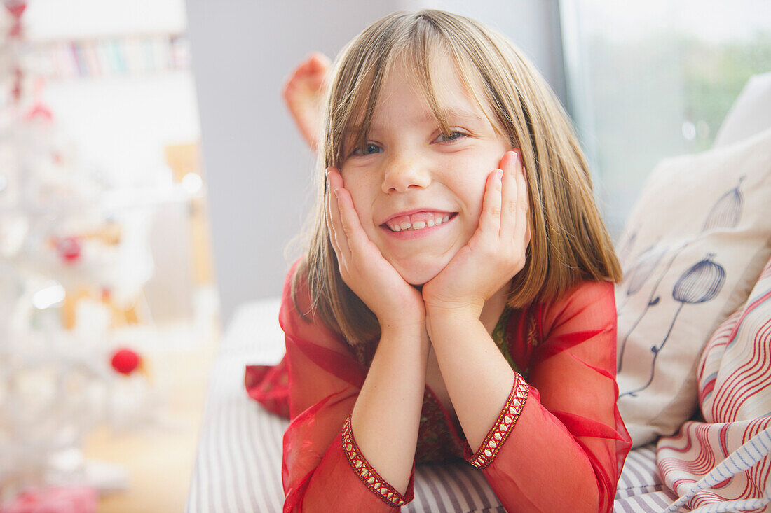 Smiling Young Girl with Hands on Face