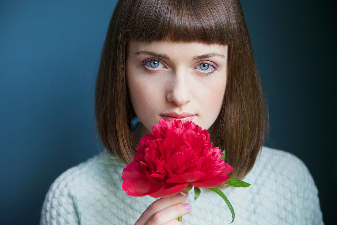 Close up of Teenage Girl Holding Red Peony