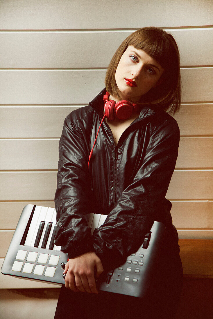 Portrait of Teenage Holding Synthesizer