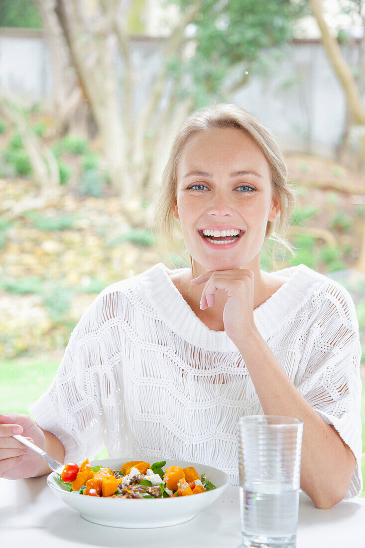 Smiling Woman Eating Salad