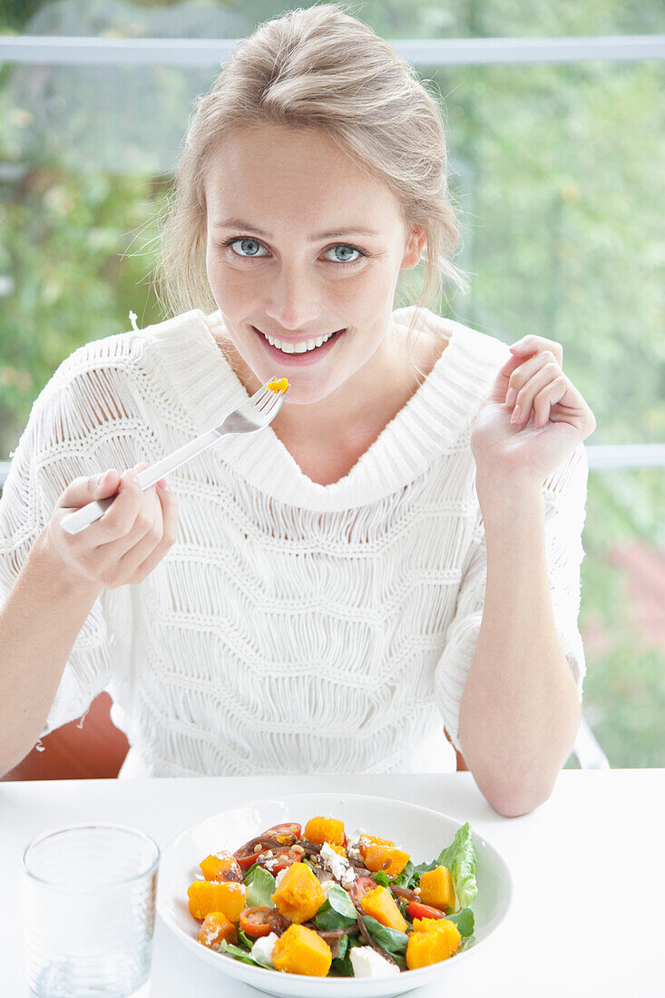 Smiling Woman Eating Salad