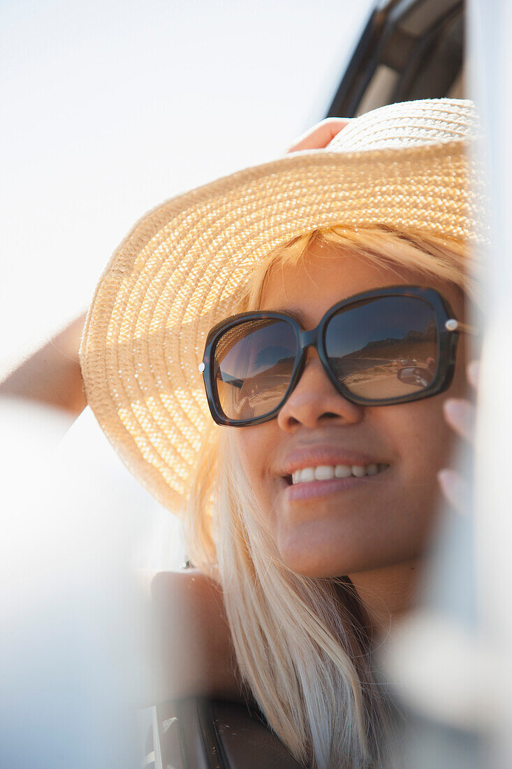 Woman Looking out of Car Window Smiling